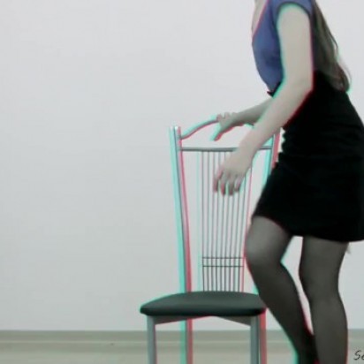 Teen posing and spreading her legs on a armchair