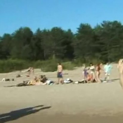 Slim teen with perky boobs naked at a nudist beach